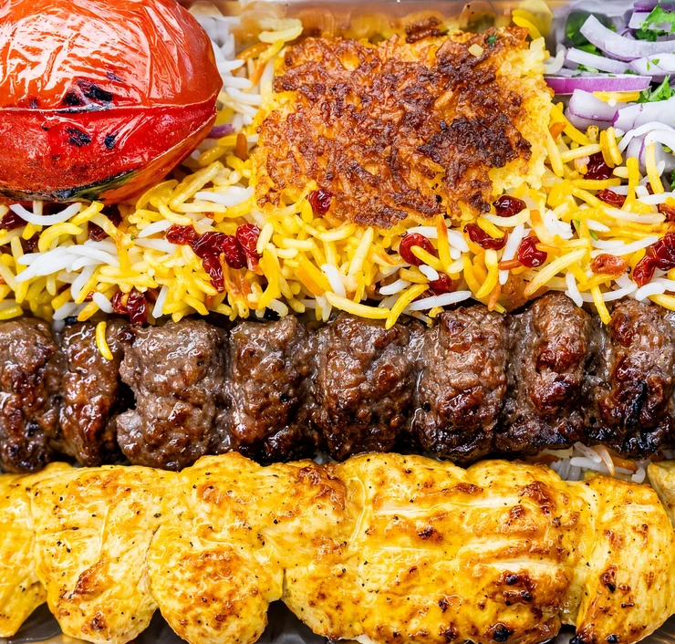 Vaziri: one beef koobideh skewer and one saffron chicken skewer with saffron rice, tahdig and a grilled tomato at AFRA Grill, Saskatoon